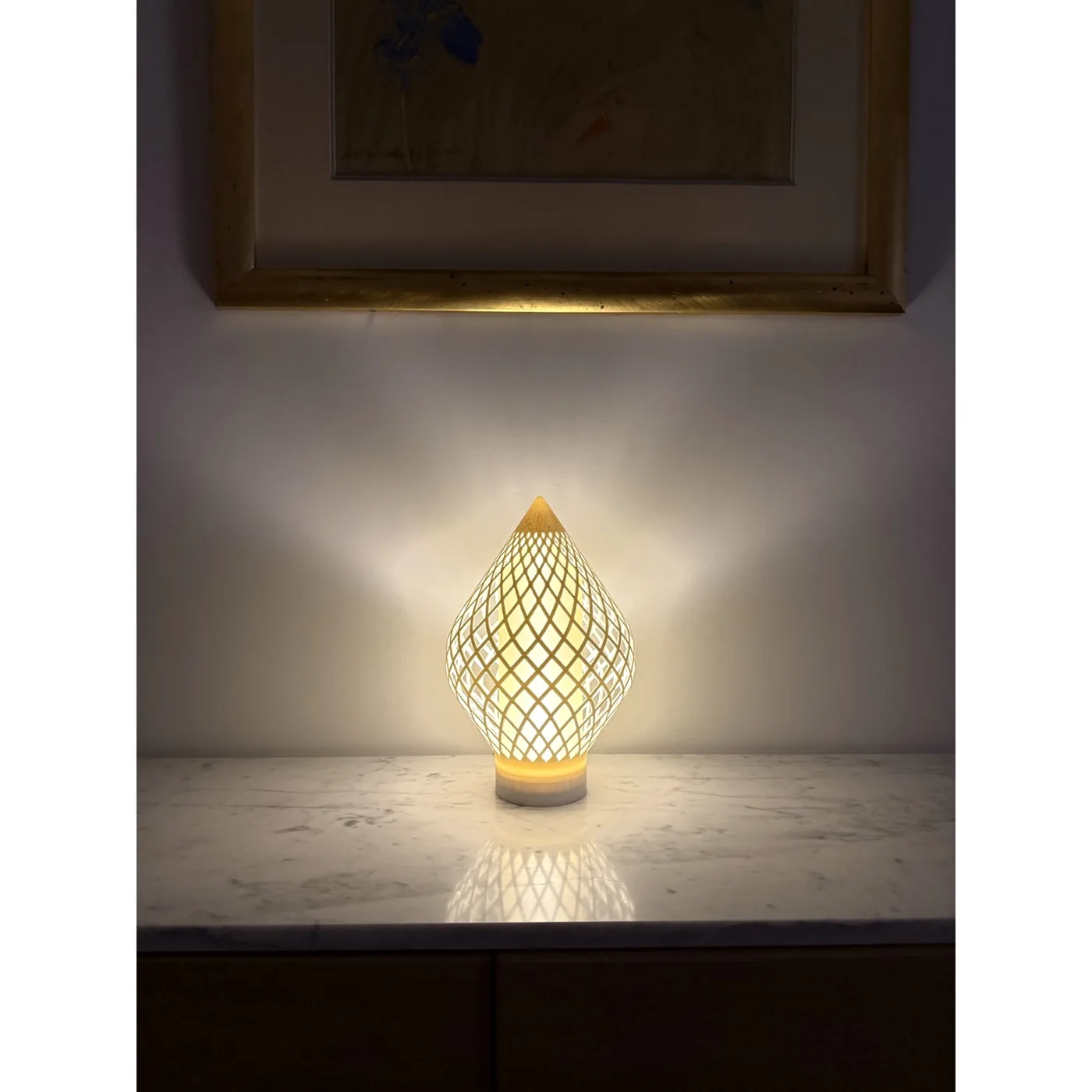 Reef Diagrid lit on a shelf at home, showing its scale in a room